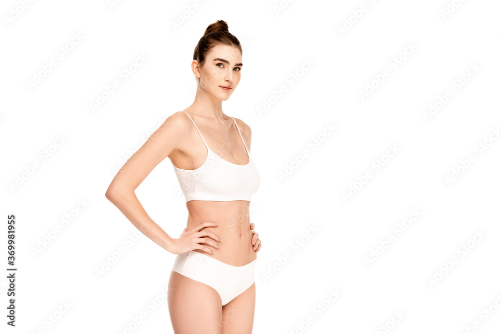 young woman in top and panties standing with hand on hip and looking at camera isolated on white young woman in top and panties standing with hand on hip and looking at camera isolated on white