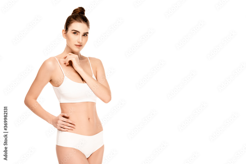 young model in top and panties standing with hand on hip and looking at camera isolated on white young model in top and panties standing with hand on hip and looking at camera isolated on white