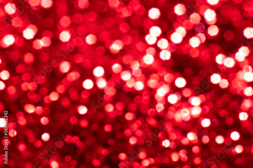 Red glitter festive background with bokeh lights. Celebration concept for Holidays and anniversary.