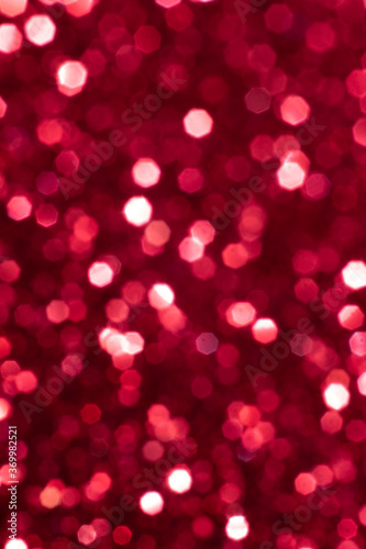 Red glitter festive background with bokeh lights. Celebration concept for Holidays and anniversary.