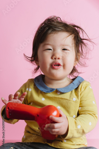 Baby girl with power drill photo