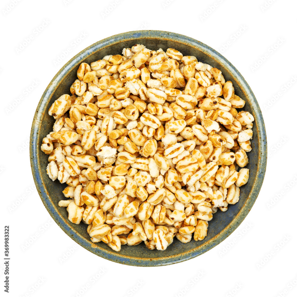 Stoneware bowl filled with puffed honey wheat cereal Stoneware bowl filled with puffed honey wheat cereal