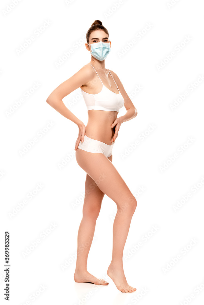 barefoot woman in medical mask, top and panties standing with hand on hip isolated on white barefoot woman in medical mask, top and panties standing with hand on hip isolated on white