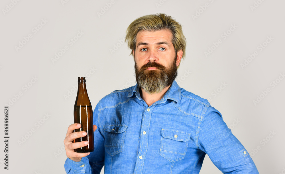 bearded man has hangover. mature man drink beer. healthy water in glass bottle. brutal hipster drinking alcohol beverage. beer and football. relax after working day. lets have fun bearded man has hangover. mature man drink beer. healthy water in glass bottle. brutal hipster drinking alcohol beverage. beer and football. relax after working day. lets have fun