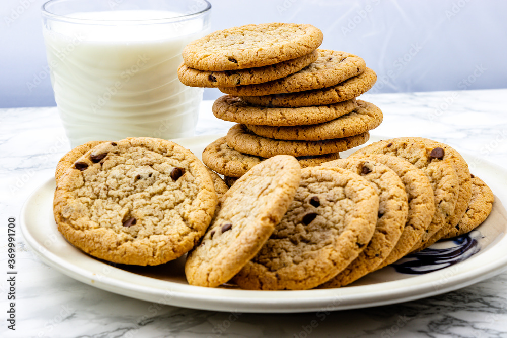 Chocolate chip cookies on a plate with milk. Calgary, Alberta, Canada Chocolate chip cookies on a plate with milk. Calgary, Alberta, Canada