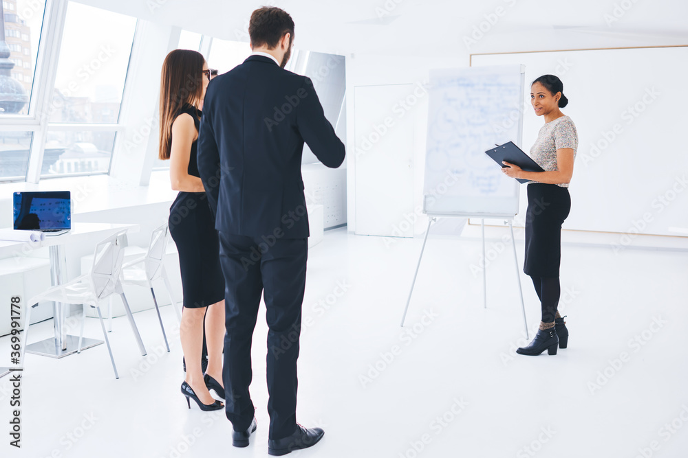 Senior manager of financial activity coaching young male and female economists in conference hall for creating new business project and organization teamwork seminar for employees and leadership Senior manager of financial activity coaching young male and female economists in conference hall for creating new business project and organization teamwork seminar for employees and leadership