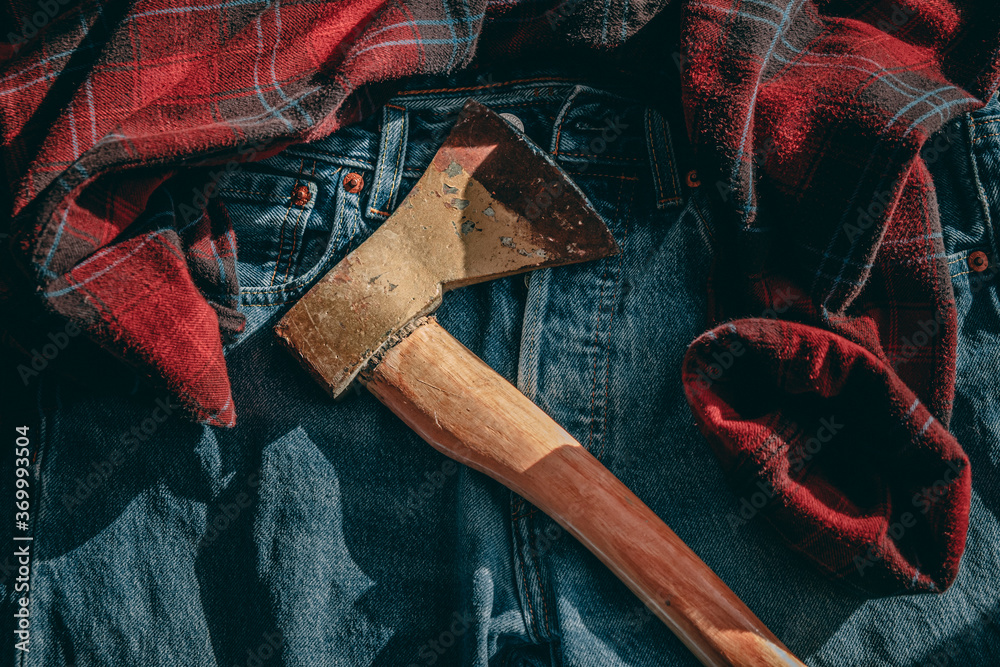 an old ax lies on a checkered red shirt and blue jeans. lumberjack  equipment, Norwegian, Canadian Stock Photo | Adobe Stock