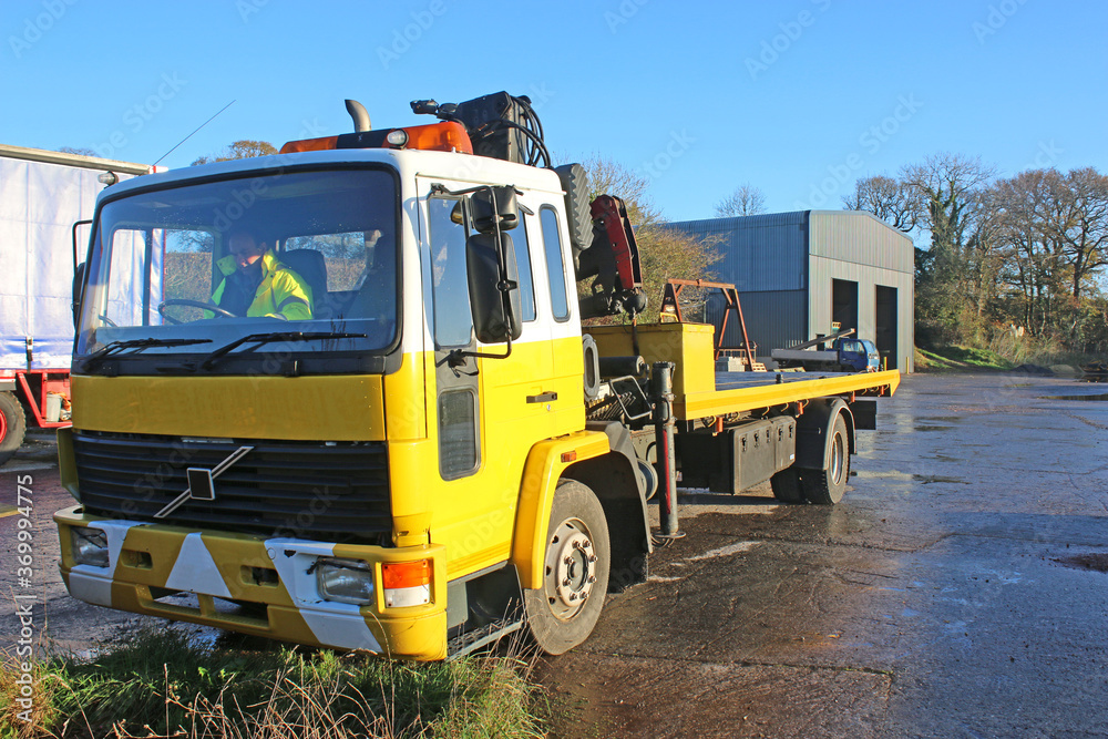 man driving a recovery truck	
