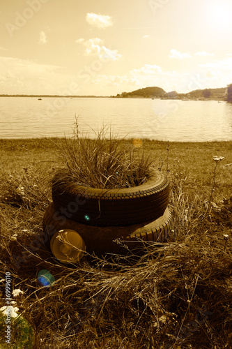 Old tires on the beach of a recreation center serving as a flowe