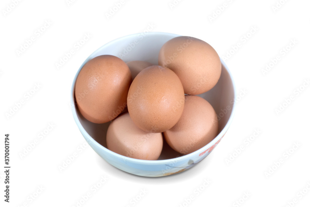 Raw chicken eggs in a bowl isolated on white background with clipping path. Raw chicken eggs in a bowl isolated on white background with clipping path.