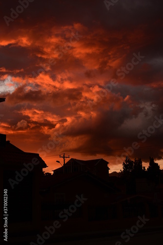 The sun is setting in a burnt orange sky as the city transforms into beautiful black silhouettes