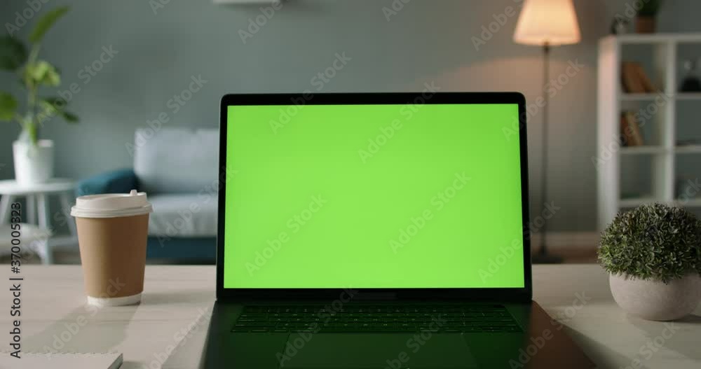 Modern laptop with mock up chroma key green screen st on desk of living room. The only template you need - remote work concept close up 4k video Modern laptop with mock up chroma key green screen st on desk of living room. The only template you need - remote work concept close up 4k video