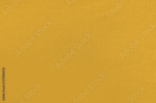 Mango homogeneous background with a textured surface, fabric.