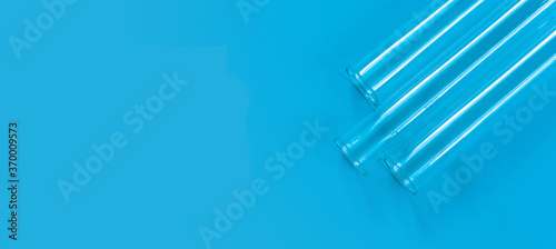 Fototapeta Naklejka Na Ścianę i Meble -  Chemical test tubes on a blue background with a blank space for your text.