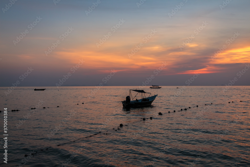 A speed boat at Melina Beach, Tiomen Island, at sunset, Malaysia
