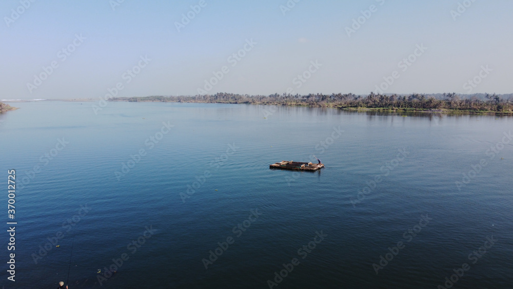 a bamboo raft is driving on the Opak river