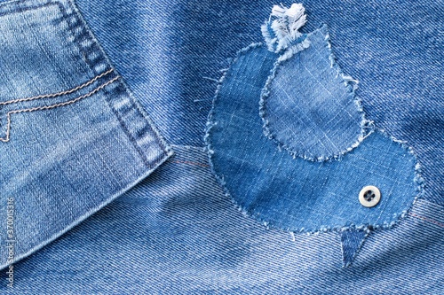 Little jeans bird - blue denim jeans patchwork pattern. Concept of old jeans reuse and natural resources preserving. 