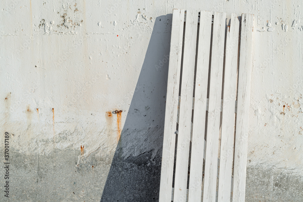Wooden boards stand against the concrete wall Wooden boards stand against the concrete wall