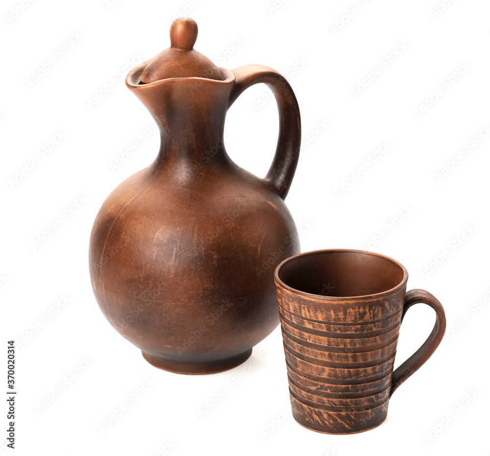 Clay jug with a mug - typical handmade products on a white background isolated