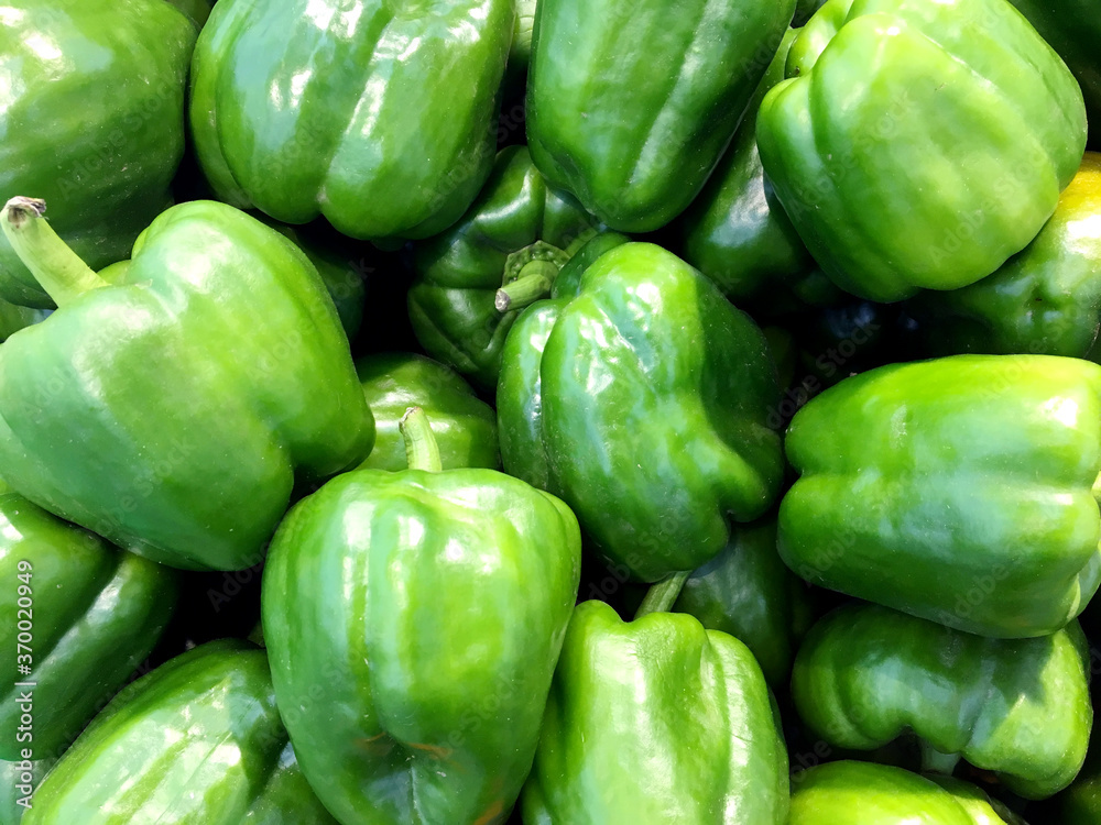 fresh green bell peppers on the counter of healthy food grocery store fresh green bell peppers on the counter of healthy food grocery store