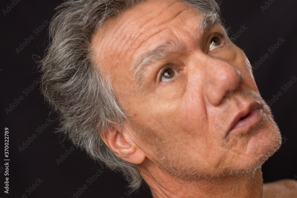  Distraught unshaven senior man at home looking depressed and tired of being locked down