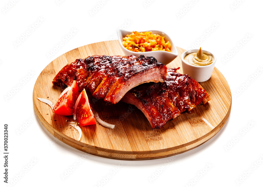 Barbecued ribs and vegetables on white background
Barbecued ribs and vegetables on white background
