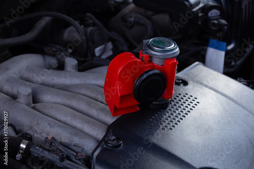 Red air horn for a car on a car engine. Electric Car air horn
