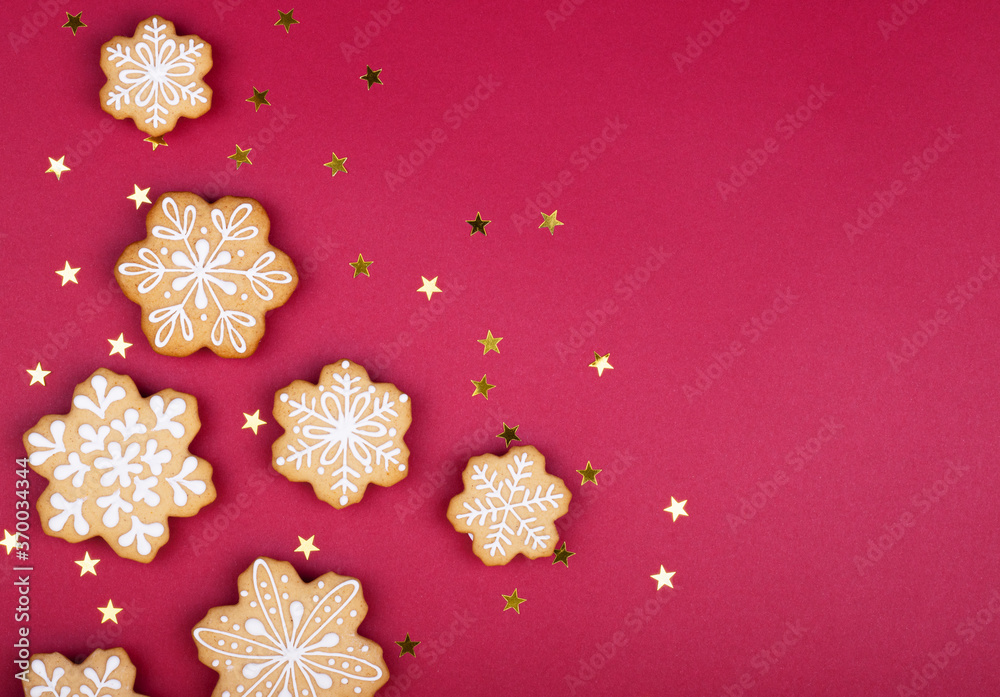 gingerbread snowflakes on a dark red background with copy space for text gingerbread snowflakes on a dark red background with copy space for text