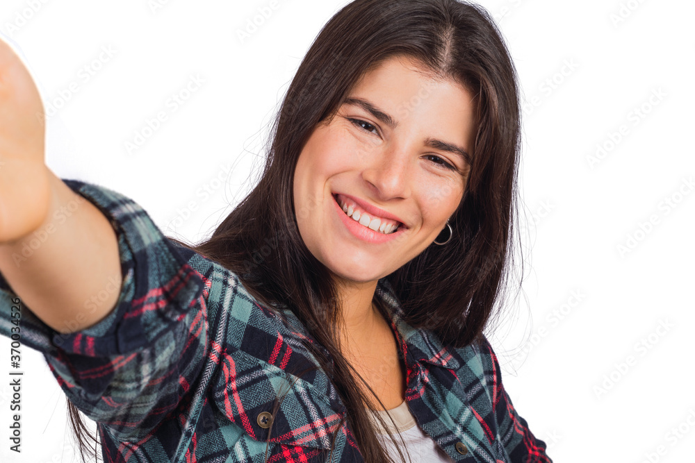 Young woman looking at camera and taking a selfie. Young woman looking at camera and taking a selfie.