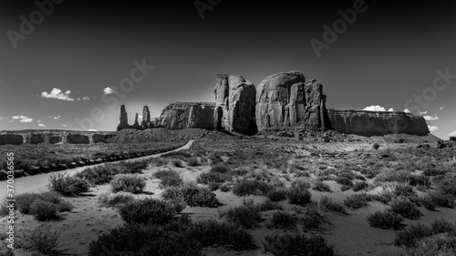 Black and White Photo of the Three Sisters and Mitchell Mesa  a few of the many massive Red Sandstone Buttes and Mesas in Monument Valley  a Navajo Tribal Park on the border of Utah and Arizona  USA