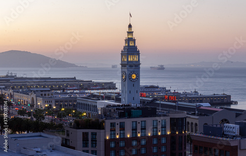 San Francisco Ferry Building with large container ship on San Francisco bay in background