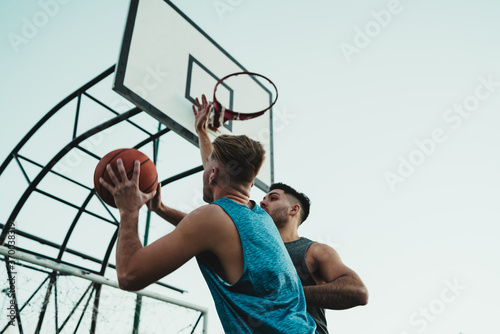 Young basketball players playing one-on-one.