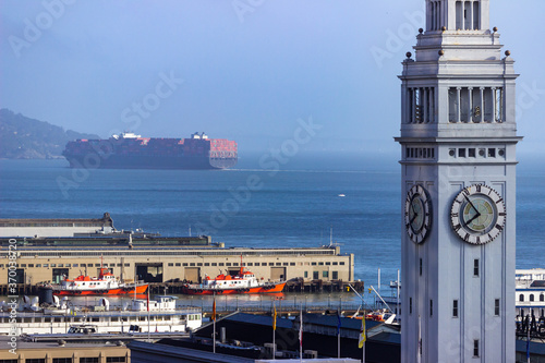 San Francisco Ferry Building with large container ship on San Francisco bay in background