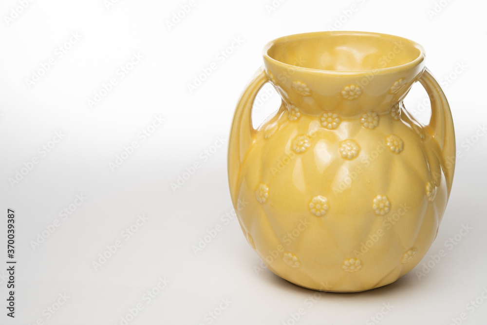 Antique yellow ceramic vase isolated on a white background Antique yellow ceramic vase isolated on a white background