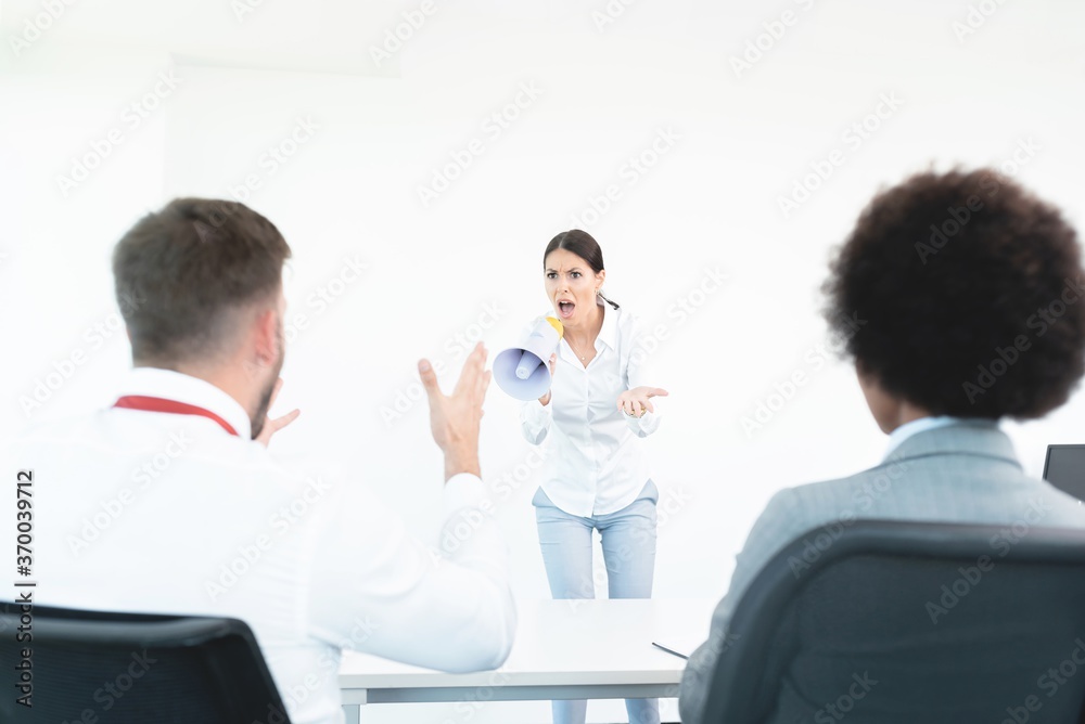 Business colleagues arguing during team meeting at office Business colleagues arguing during team meeting at office