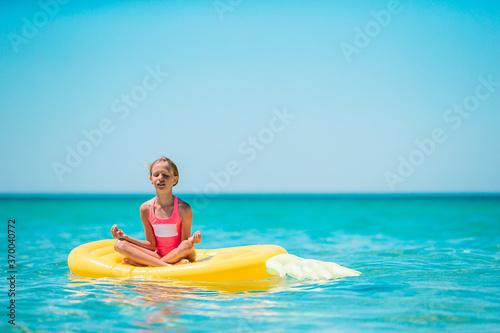 Adorable girl on inflatable air mattress in the sea © travnikovstudio