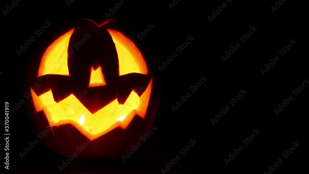 Jack-o-lantern carved out pumpkin head long footage with candles inside. Halloween concept. Jack-o-lantern carved out pumpkin head long footage with candles inside. Halloween concept.