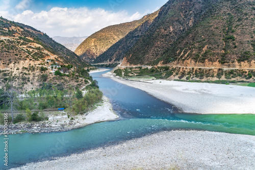Confluence of two mountain rivers with different colors of water, in the shape of a letter 