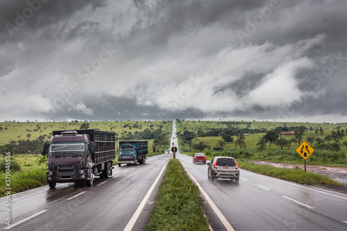 Scene of a road on rainy day, with vehicles