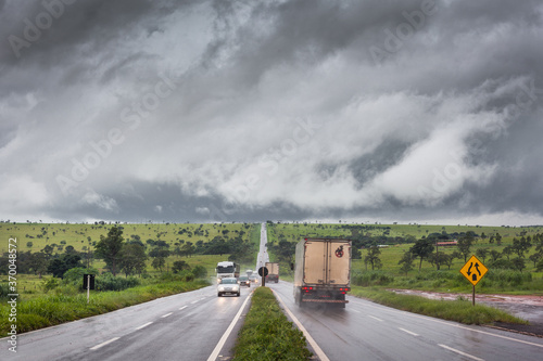 Scene of a road on rainy day, with vehicles