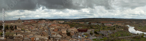 Culture and history. Architecture. Cityscape. Panorama view of the town and buildings under a cloudy sky in Toledo, Spain.