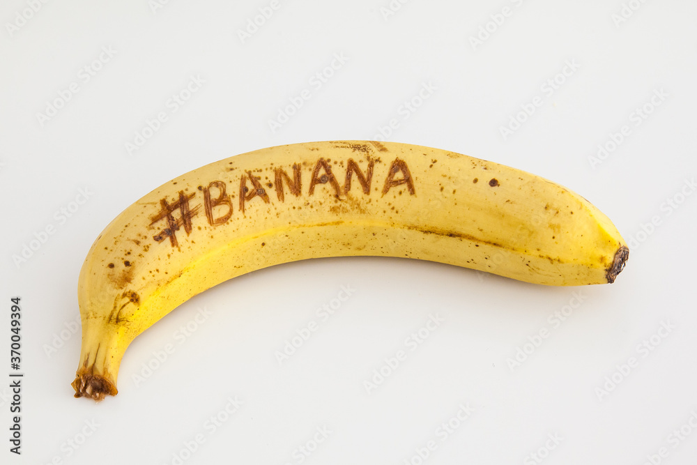 Banana with white background and text on fruit