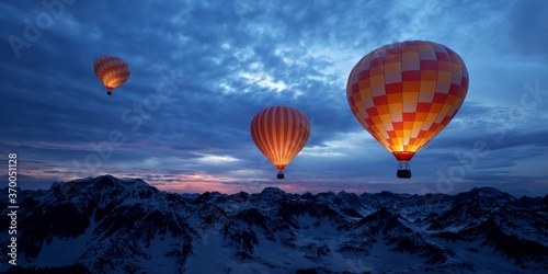 Hot air balloons traveling through the mountains. 