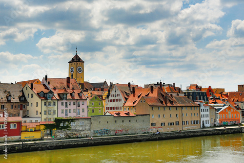Regansburg, Germany; A cityscape of Regansburg, germany. A clock tower and many homes and apartment buildings.