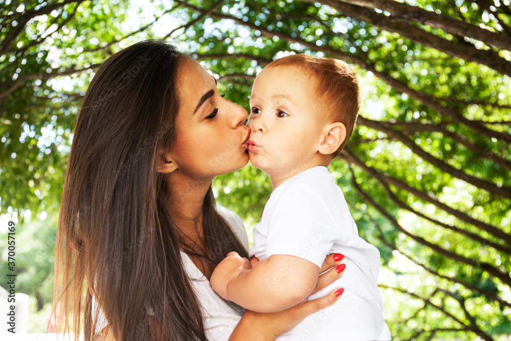 young pretty brunette mother with little cute boy walking in park happy smiling, lifestyle people concept young pretty brunette mother with little cute boy walking in park happy smiling, lifestyle people concept