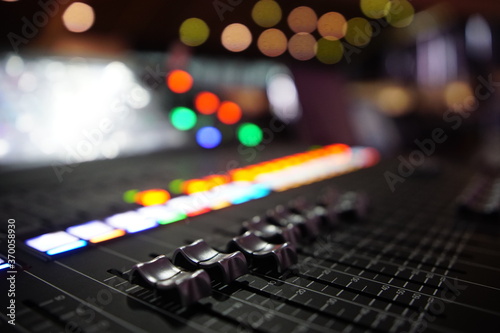 Black audio sound mixer with sliders button. Bokeh background