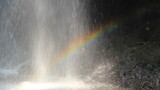 rainbow blurry behind a fresh waterfall