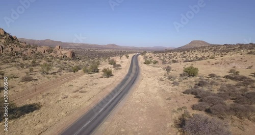 4K aerial drone video of African savanna hills, large red granite boulders range near B1 highway south of Windhoek in central highland Khomas Hochland of Namibia, southern Africa photo