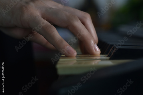 Fingers playing piano on the keys