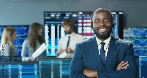 Wallpaper Mural Portrait of African American man in suit and tie with headset smiling to camera in stock exchange office. Trading concept. Professional trader man in room with monitors and computers. Sales manager. Torontodigital.ca